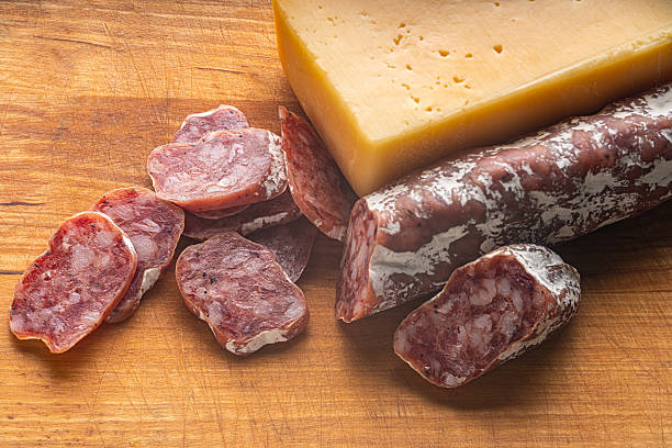 dried sausage and cheese on a wooden kitchen board