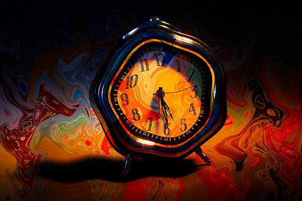 Surreal abstract composition featuring a distorted vintage alarm clock with a glowing orange face, surrounded by fluid, flame-like color swirls and liquid textures. The warped numerals, melting contours, and dynamic motion effects evoke the sensation of time bending and dissolving into energy and emotion. This visually intense image symbolizes the passage of time, urgency, pressure, transformation, and altered perception of reality.