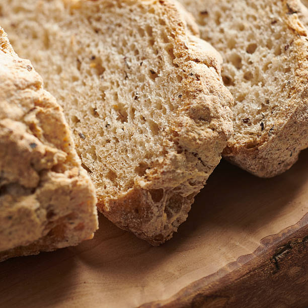 Overhead views and close-up shots of sliced gluten free bread arranged on wood and light surfaces. The bread is made with corn flour, showing a dense crumb and rustic texture. Natural light and minimal styling highlight artisanal baking, texture, and everyday food concepts.