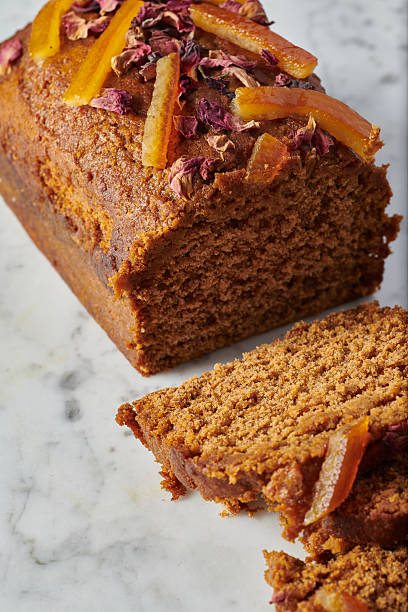Gluten free gingerbread loaf sliced on marble background