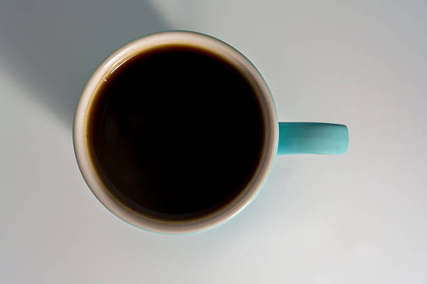 A hot cup of coffee on table in autumn