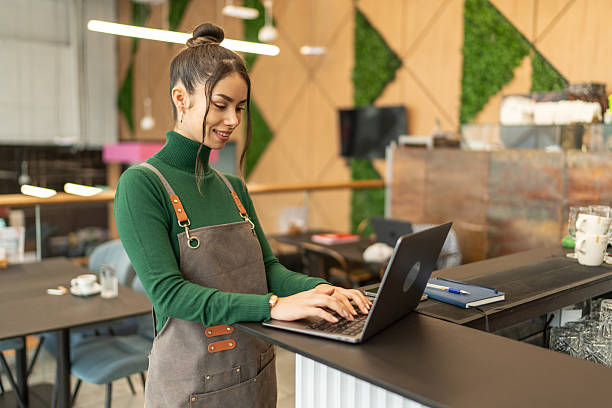 istock Woman wearing apron using laptop managing small business 2257785118