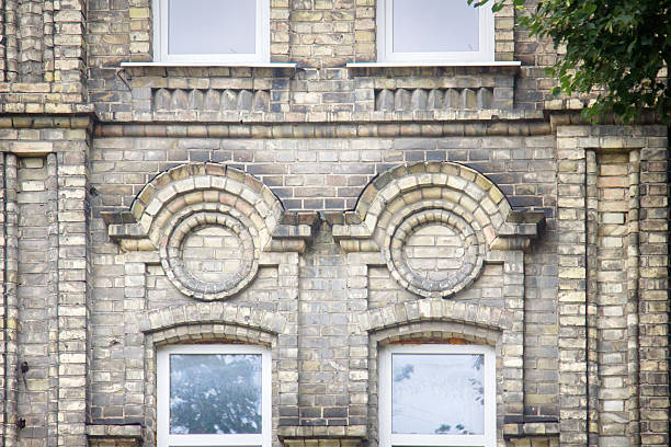 Several windows in a row on facade of urban apartment building front view, St. Petersburg, Russia.