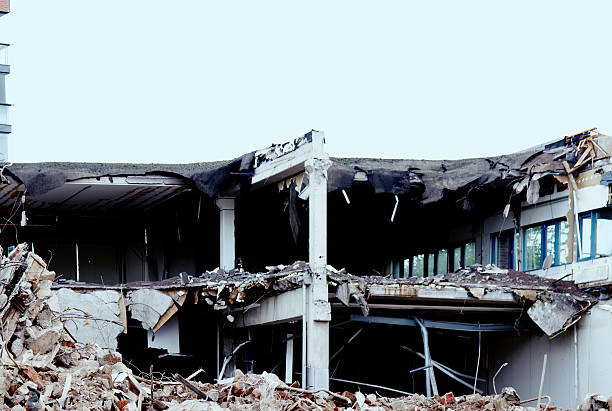 Ruins of old houses during demolition. Walls with ceilings and windows