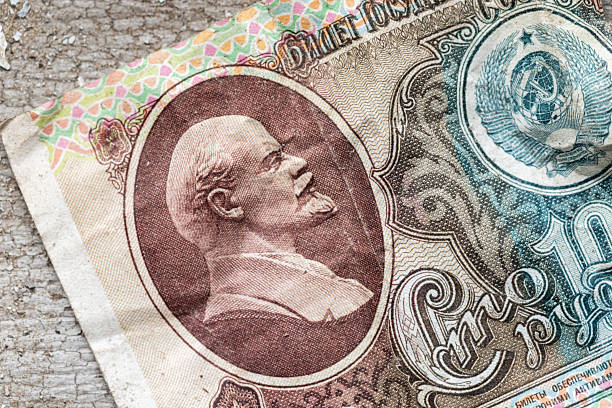 Close-Up image of a vintage Soviet banknote featuring Lenin profile portrait and Coat of Arms. The worn paper texture and intricate patterns convey history, currency art, and cultural heritage
