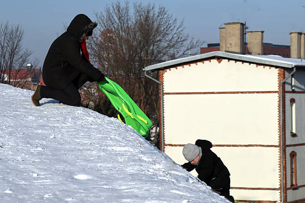Woman having fun in the now on a sled