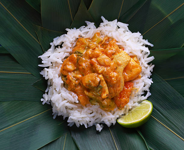 A banana leaf with rice and curry gravy, papadom (fried crackers), three types of vegetable and two types of meat. The benefits of banana leaf is not only serve as a plate but also it brings out flavour to a person's meal.