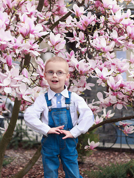 Small cute boy smelling daffodilFor more photos and videos of children and flowers click here