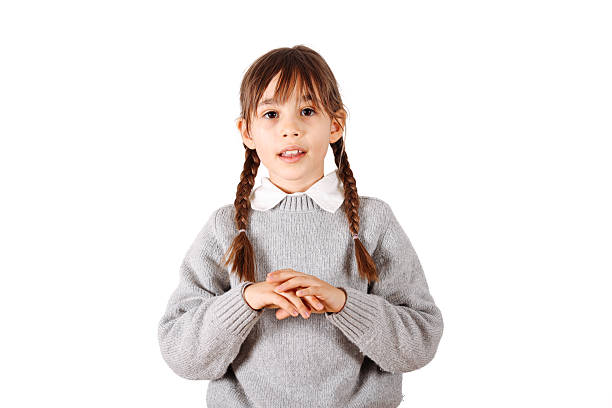 Brunette hispanic girl wearing grey sweater with a big smile on face, pointing with hand and finger to the side looking at the camera.