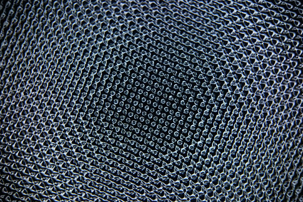 Macro shot highlighting a dense mesh texture with circular repeats. The deep blue palette and subtle reflections create a modern, industrial feel suitable for design, fabric, or tech projects.