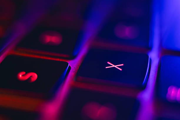Backlit keyboard showing red and blue neon lights creating a modern technology concept