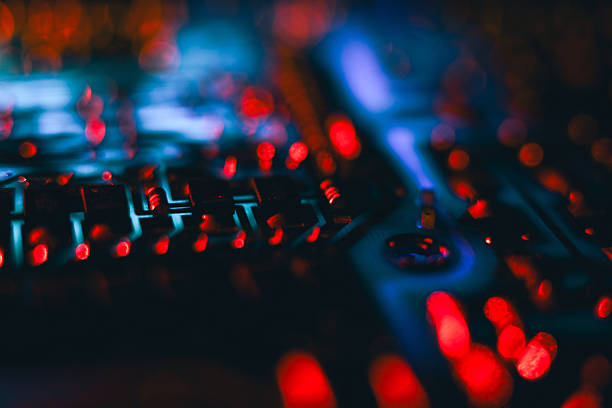 Abstract close-up on a computer circuit board lit with vibrant red and blue colors