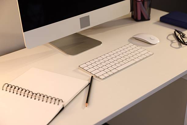 Desk with computer and stationery at home office, closeup. Interior design