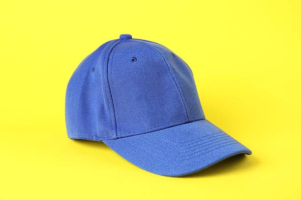 One blue baseball cap on yellow background, closeup. Mockup for design