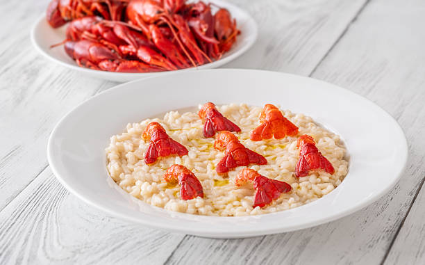 Creamy Italian risotto topped with crawfish tails and olive oil, bright gourmet styling
