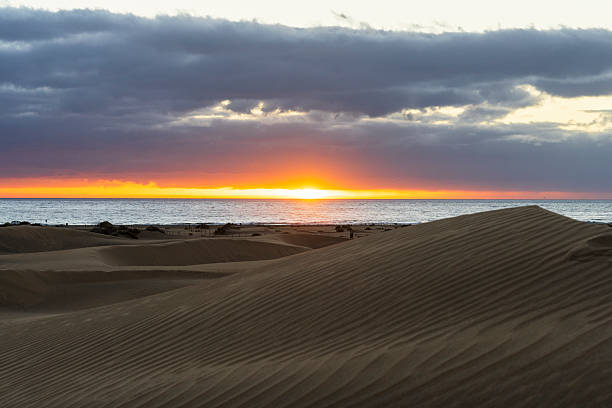 Sunrise over sand dunes surrounding the ocean, Gran Canaria, Canary Islands, Atlantic Ocean, Spain