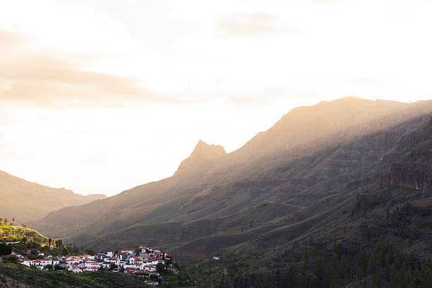 Small hilltop village nestled among impressive mountains in the soft afternoon light, Fataga, Gran Canaria, Canary Islands, Atlantic Ocean, Spain
