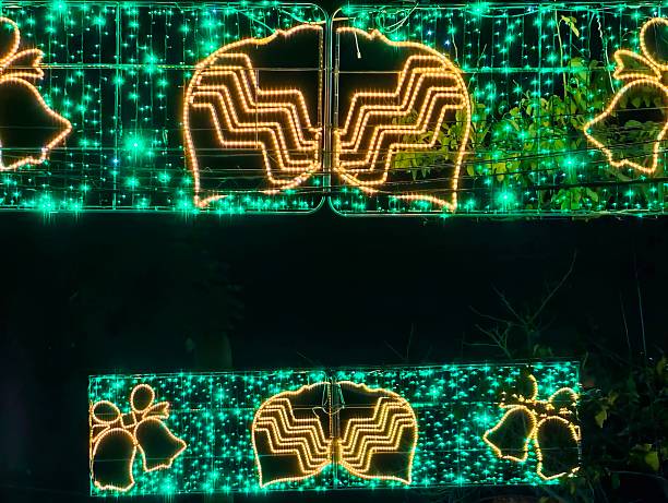 Green Neon Bell Panels Over Street, Dynamic Festival Lighting With Geometric Patterns And Shimmering