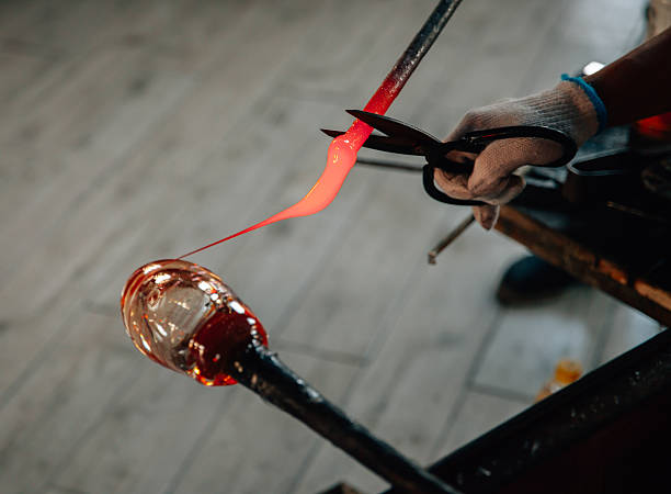 Traditional glassblowing worker making glass crafts