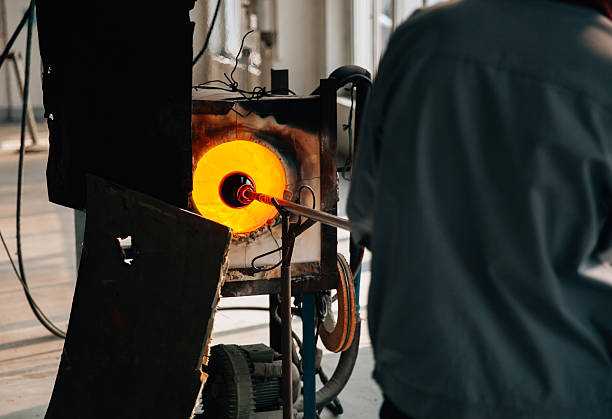 Traditional glassblowing worker making glass crafts