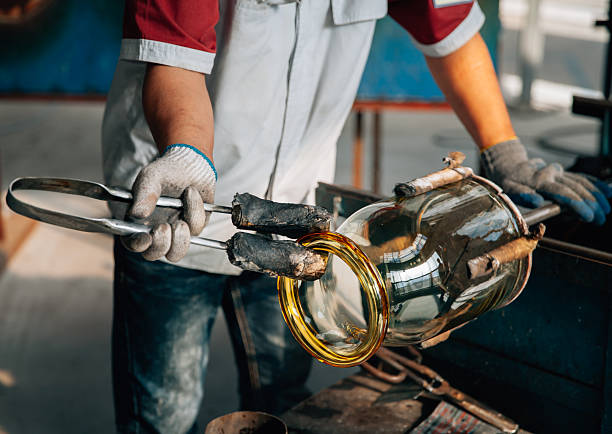 Traditional glassblowing worker making glass crafts