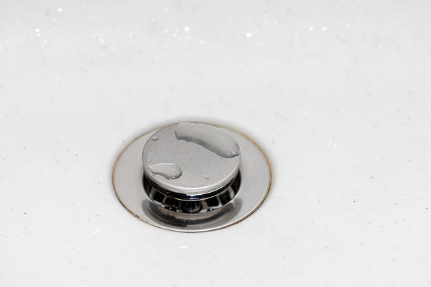 Wet drain at the bottom of a white sink