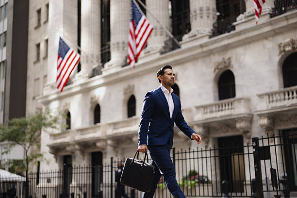 istock Financial professional man walking on Wall Street with briefcase 2257882223