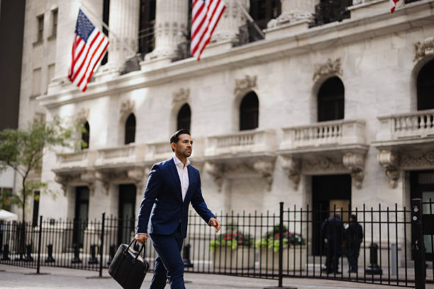istock Professional businessman walking with briefcase on Wall Street 2257882749