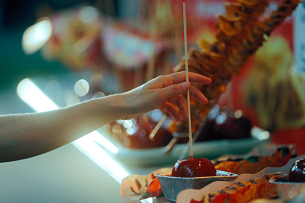Person reaches for a sweet treat at a funfair market