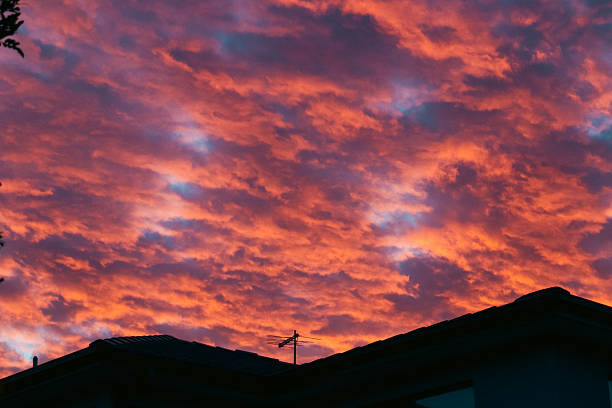 Wide panorama of a sunset with golden and orange colors predominating on clouds