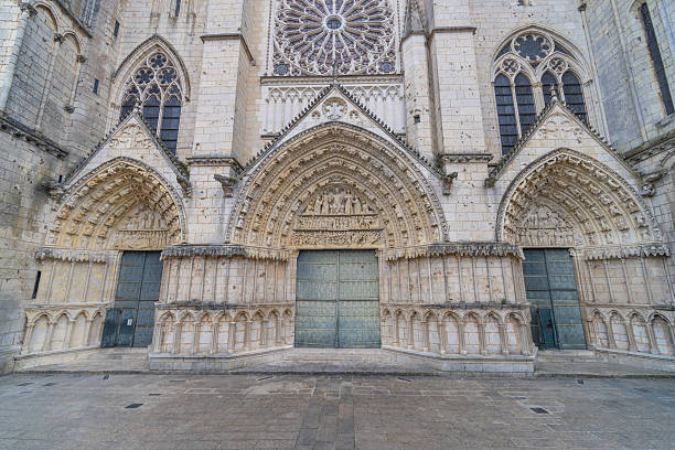 Historical Gothic architecture featuring detailed sculptures and a grand rose window on the facade