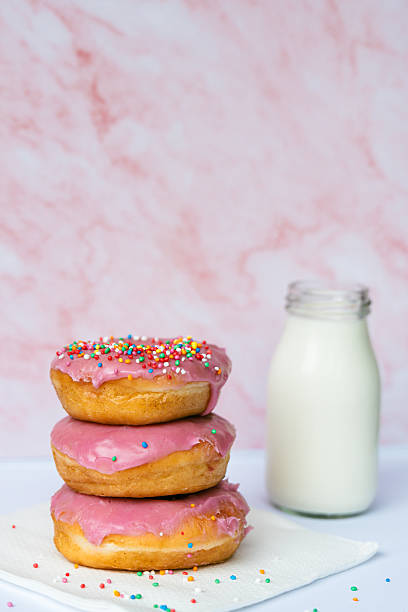 Pink Donuts With Sprinkles and Milk on Pastel Background