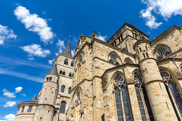 Trier Cathedral facade with towers and intricate details under a bright blue sky