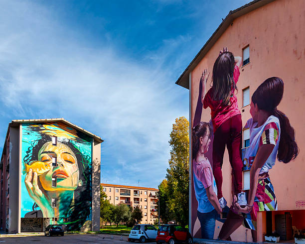 Beautiful Brazilian girl spray painting a mural on the side of a building