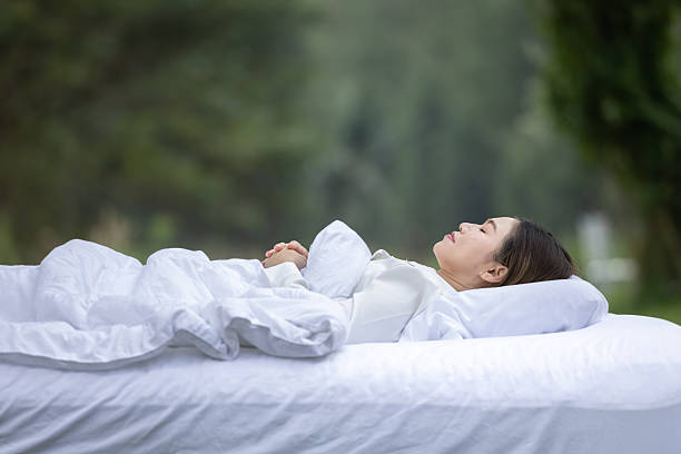 Young woman sleeping peacefully in bed resting.Young woman sleeping on a white pillow with eyes closed.