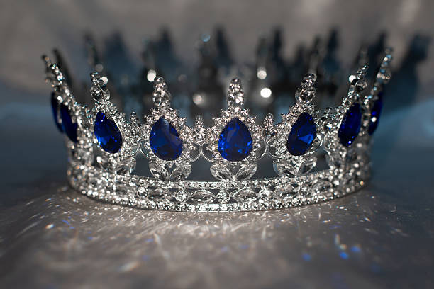 A king or queens crown in vibrant blue and pink colors.  Concept of royalty, leadership, and a kingdom.