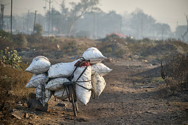 Bicycle loaded with heavy coal sacks in Dhanbad India
