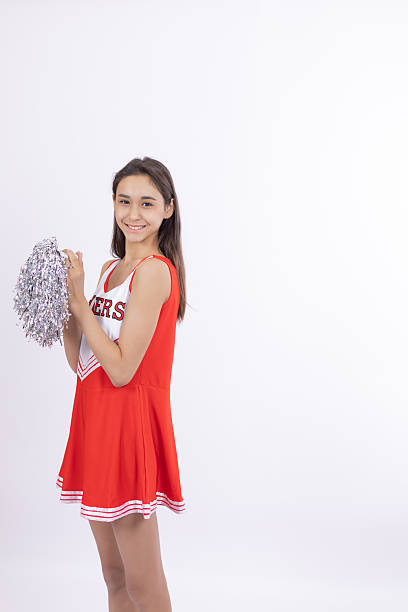 A young woman in a dance outfit looking at the camera.
