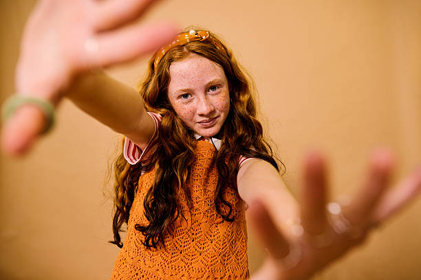 Portrait of a pretty 7-year-old Caucasian girl with ginger hair and blue eyes.