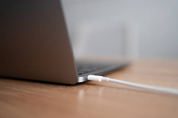 Laptop connecting to power using a white usb-c charging cable