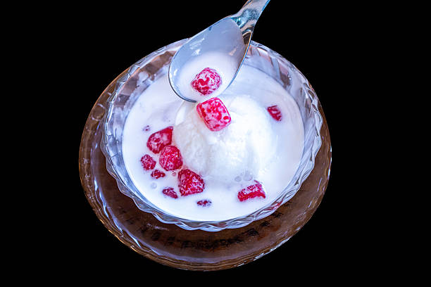 A bowl filled with fresh raspberries, creamy texture, and crunchy wafers.