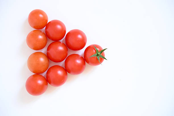 Six red small tomatoes organized on a white backdrop. High-quality imagery for organic farming, eco-products, and nutritious diet projects.