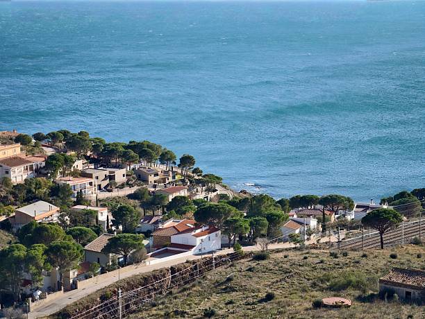Hillside Village Above Turquoise Sea With Terracotta Roofs, Pine Trees And Winding Lanes Leading To Bayside