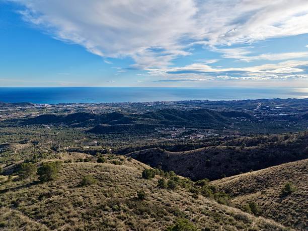 Open Hilltop Overlooking Coastal Plain And Distant City Skyline, Urban Planner Perspective Showing