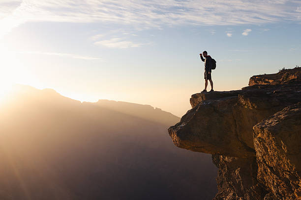 istock Backpacker standing on cliff edge overlooking canyon in Oman 2257965346