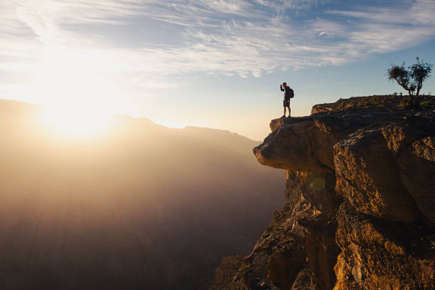 istock Backpacker standing on cliff edge overlooking canyon in Oman 2257965516