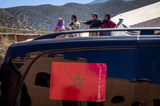 Residents receive aid from local vehicles days after the 2023 earthquake in Morocco.