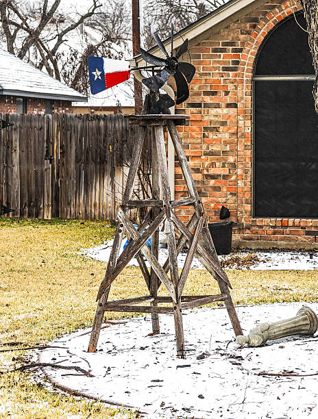 Lawn ornament of a windmill with a Texas flag on a sleet covered ground after a snow storm near Fort Worth, Texas, January, 24, 2026.
