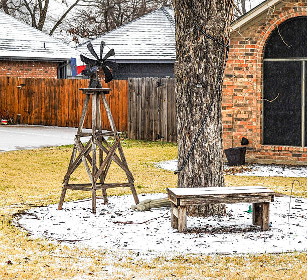 Lawn ornament of a windmill with a Texas flag on a sleet covered ground after a snow storm near Fort Worth, Texas, January, 24, 2026.