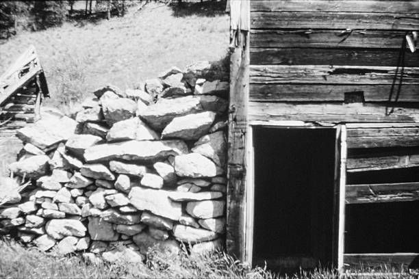 Details of the ghost town (or rather ghost village) Anavatos in the mountains of the Greek Island of Chios in the Aegean Sea in summer (July) in black and white. Anavatos (Greek: Ανάβατος) is a medieval, now abandoned, village located 16 km north-west of Chios Town. The village was established in the Byzantine era, probably by workers of the nearby Monastery of Nea Moni. Above the village stands a medieval fortress. The village was abandoned after the Turkish massacre in 1822 and the devastating earth quake in 1881.The image was captured on old-fashioned black and white grainy ISO 400 film by an analogue 35 mm film camera. The granularity is real film grain (due to the presence of small particles of a metallic silver on the negative). Minimal post processing has been done (only adjustment of histogram). The image is part of a series of abandoned and partly ruined houses (ghost towns) in Greece.